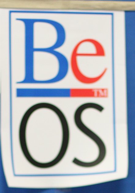 A BeOS poster on a blue backdrop at a computer festival